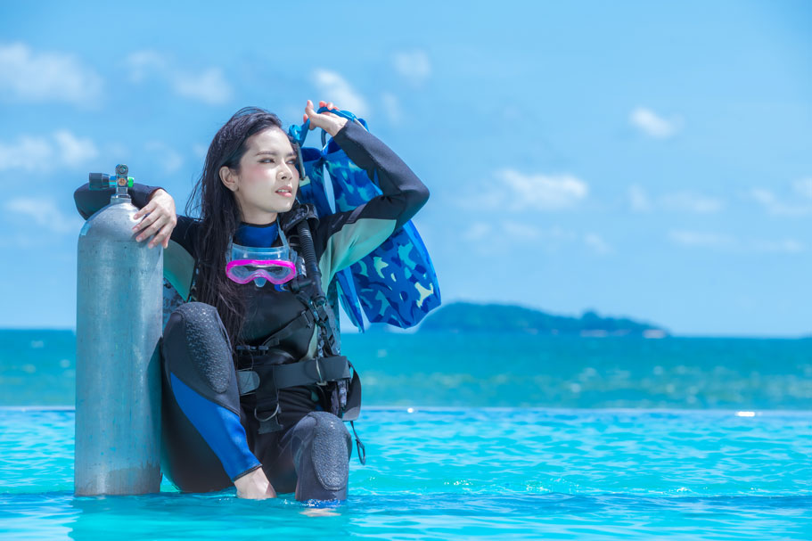 bcd buying guide - close up woman with dive gear - scubly