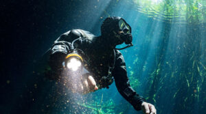 choosing the right dive light for diving needs - diver with light - scubly