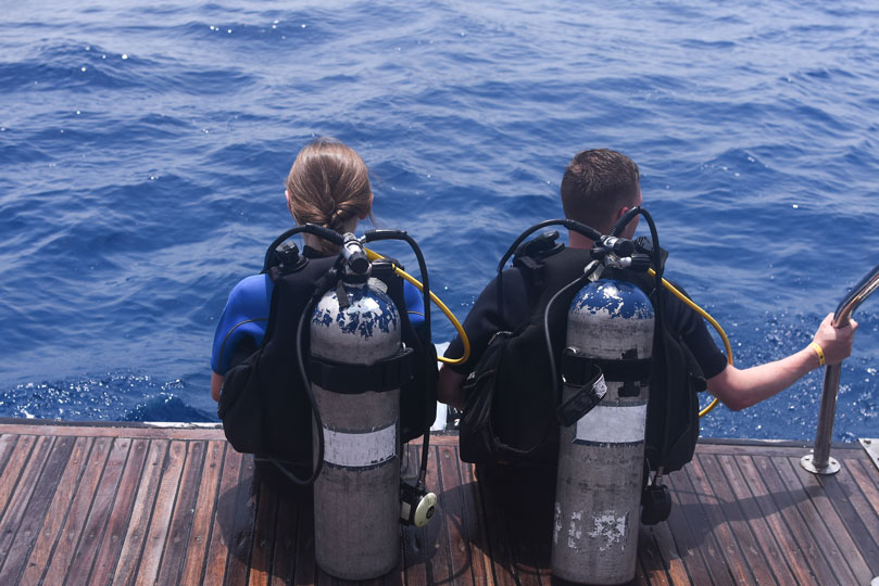 dive planning - two divers preparing to enter water - scubly