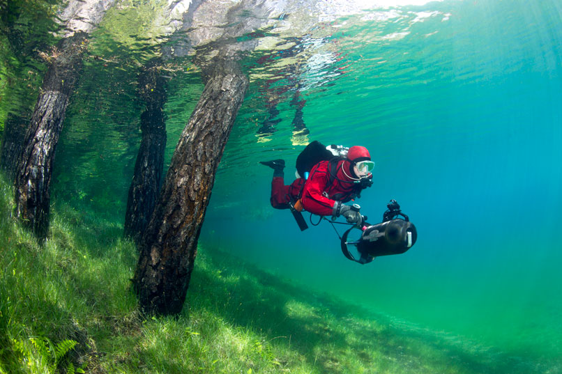 mastering dry suit diving techniques - diver swimming - scubly